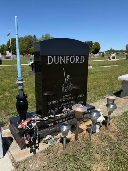 # Dane J. Dunford Obituary: Cause of Death and the Young Star Wars Fan Remembered at Age 6 Dane J. Dunford, a young Star Wars enthusiast whose courage during a battle with cancer touched his family and the Liberty Center, Ohio, community, died at home on the evening of March 15, 2016. He was six years old. Dane was born on April 23, 2009, in Wauseon, Ohio, to Jeffrey Dunford and Janey (Allen) Dunford. He was a first-grade student at Liberty Center Schools, where his story inspired people to come together to create special memories during his final months. ## A Brave Fight Against Childhood Cancer Dane was diagnosed with osteosarcoma, a type of bone cancer, when he was five. He underwent nine months of chemotherapy and surgery to remove the cancer. Unfortunately, the disease returned in early December. After attempting another round of chemotherapy, Dane and his family made the difficult decision to stop treatment so they could focus on spending meaningful time together. Despite the challenges he faced, Dane experienced several memorable adventures with the support of loved ones and people who wanted to make his remaining time special. ## Dreams Made Possible Through Love and Community Through the Make-A-Wish Foundation, Dane had the opportunity to visit Disney World. He also spent time with friends in Bloomington, Indiana, and visited relatives and friends in Utah. His hometown community helped fulfil another special dream by arranging opportunities for him to meet some of his favourite Star Wars heroes. Dane also got to experience being a scientist for a day, creating memories that his loved ones could treasure. His love of Star Wars became a lasting part of his story. For those who remember him, the image of Dane as a little Jedi represents the courage and spirit he showed while facing a serious illness at such a young age. ## A Lasting Tribute to a Special Little Boy Dane’s story continues to be remembered through tributes celebrating his personality, interests and love for the Star Wars universe. Memorials that reflect the things a person cherished can offer families and friends a deeply personal way to honour their memory. Although Dane’s life was brief, the experiences he shared with his family and the kindness shown by his community helped make his final months meaningful. ## Obituary Dane J. Dunford of Liberty Center, Ohio, died peacefully at home on March 15, 2016, aged six. He was the son of Jeffrey Dunford and Janey (Allen) Dunford. He is remembered for his bravery, his love of Star Wars and the special memories created by his family and community. ## Cause of Death Dane died following a battle with osteosarcoma, a form of bone cancer. After chemotherapy and surgery, the cancer returned. His family chose to discontinue further treatment and spend his remaining time together making meaningful memories.